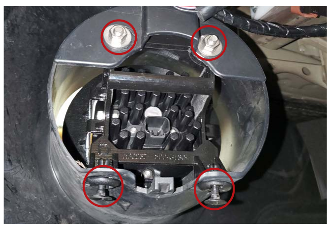 Factory Subaru Outback fog lamp mounting hardware indicated for removal