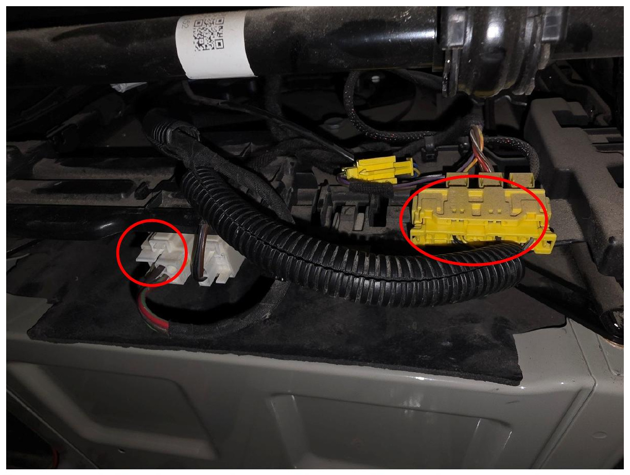 Electrical connectors beneath the driver seat