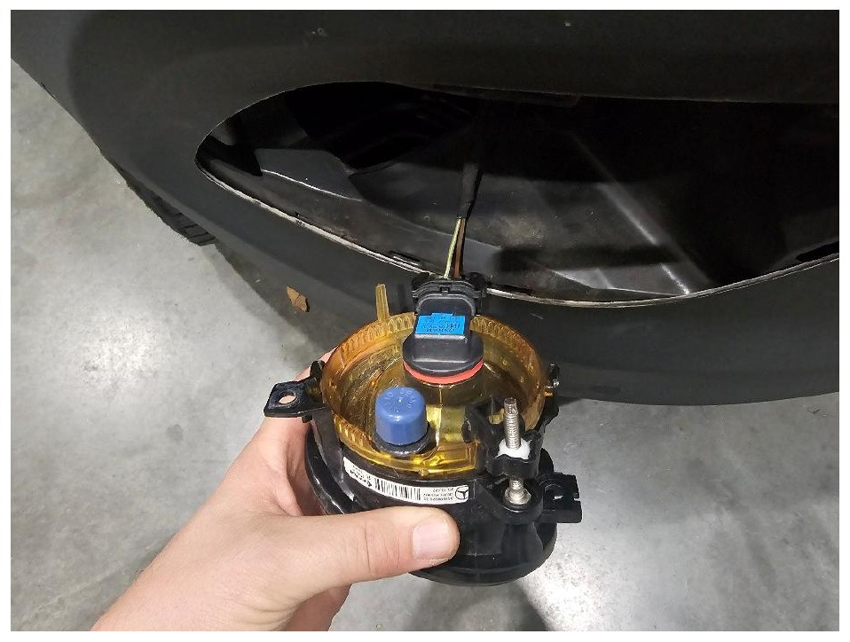 Removing and disconnecting the factory fog light
