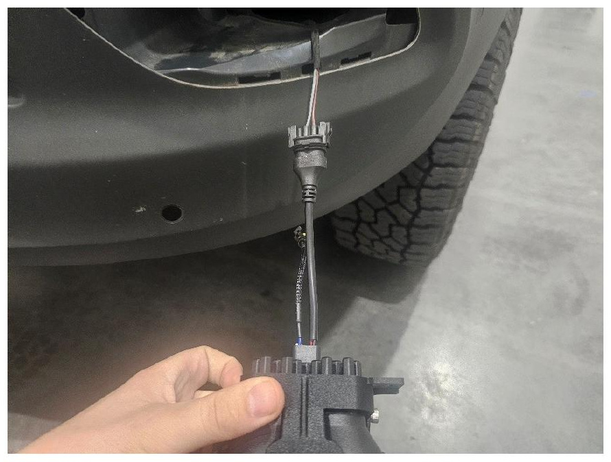 Fog light adapter connected to the factory harness